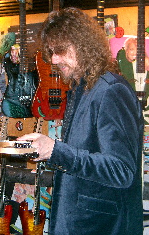 alexcheckingcharvelguitars.jpg